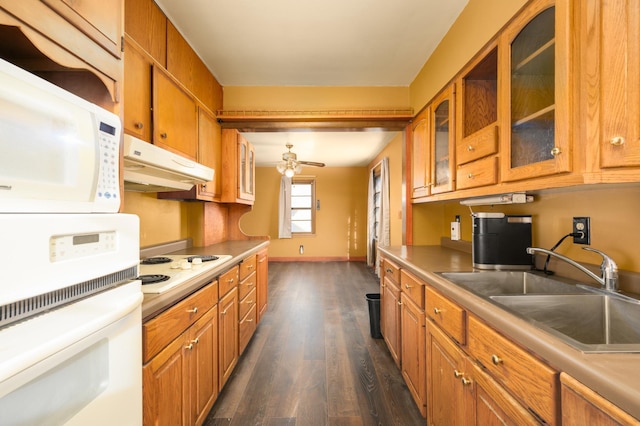 kitchen with white appliances, ceiling fan, dark wood-type flooring, and sink