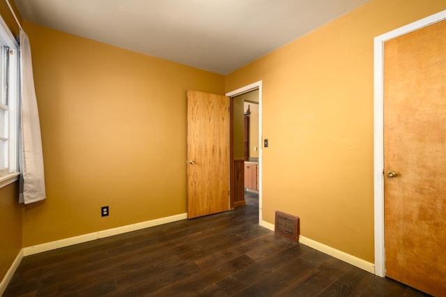 unfurnished room featuring dark hardwood / wood-style floors