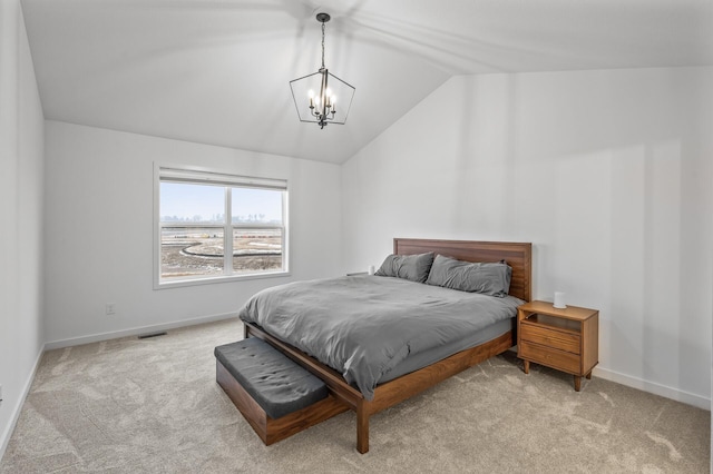 bedroom with a notable chandelier, light colored carpet, and vaulted ceiling