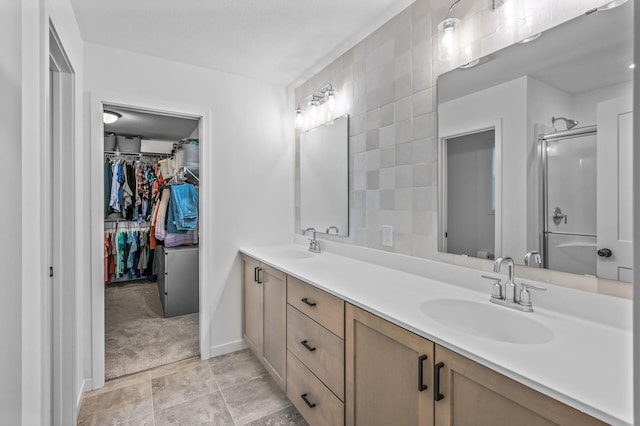 bathroom with vanity and a shower with door