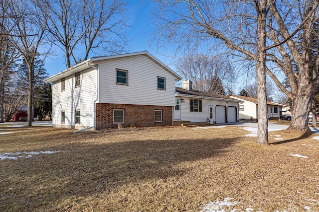 back of house featuring a garage