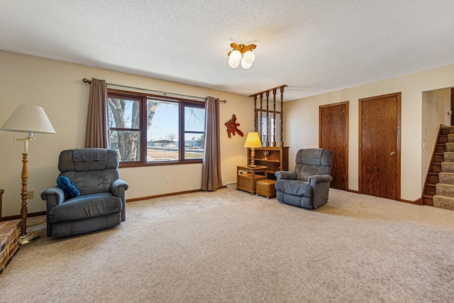 living area featuring carpet and a textured ceiling