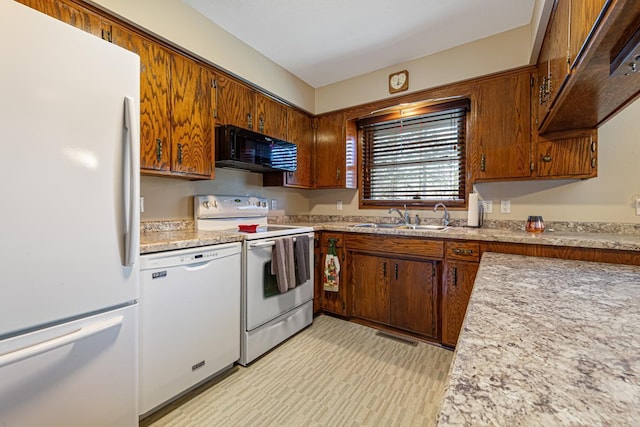 kitchen featuring sink and white appliances