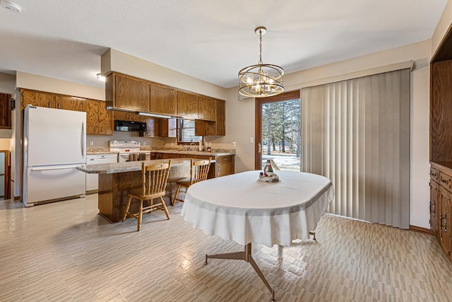 dining area with an inviting chandelier