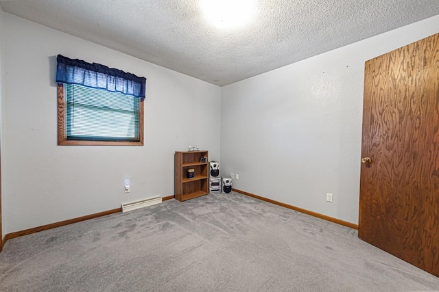 carpeted empty room with a textured ceiling