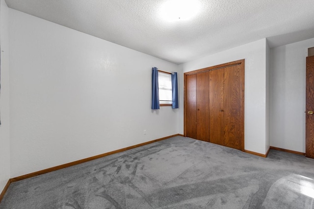 unfurnished bedroom featuring a closet, carpet, and a textured ceiling