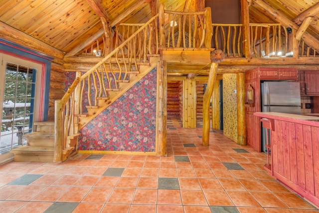 interior space featuring tile patterned floors, wooden ceiling, rustic walls, and high vaulted ceiling