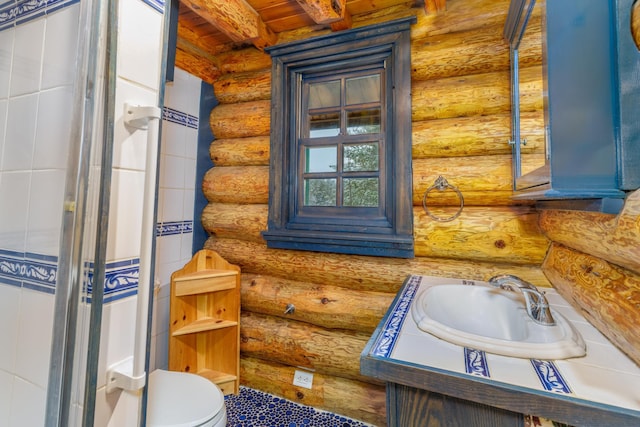 bathroom with toilet, rustic walls, wooden ceiling, and sink