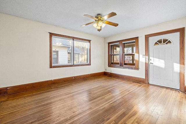 foyer entrance with hardwood / wood-style floors, a textured ceiling, and ceiling fan