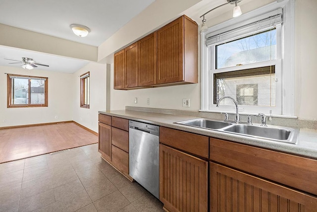 kitchen with light tile patterned floors, stainless steel dishwasher, ceiling fan, and sink