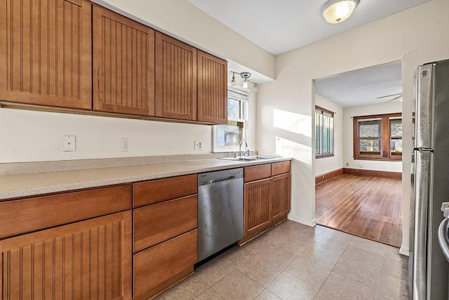 kitchen featuring ceiling fan, light tile patterned floors, sink, and appliances with stainless steel finishes