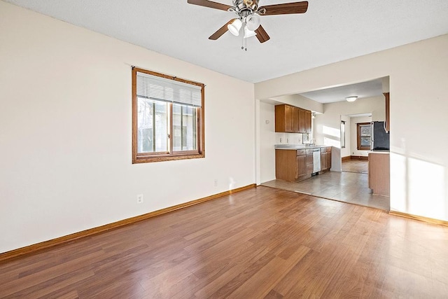 unfurnished living room with ceiling fan and light hardwood / wood-style floors