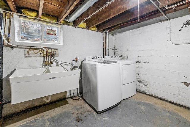 laundry area featuring washing machine and dryer and sink