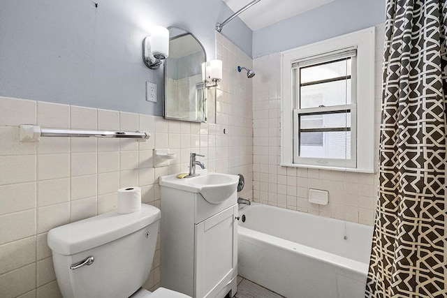 full bathroom featuring shower / bathtub combination with curtain, vanity, tile walls, and toilet