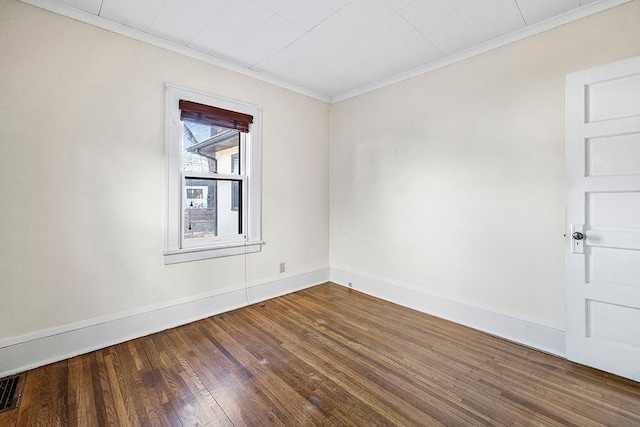 spare room with wood-type flooring and ornamental molding