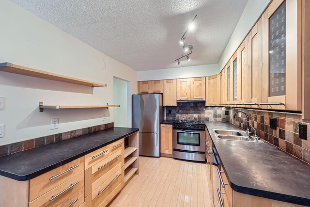 kitchen with backsplash, a textured ceiling, stainless steel appliances, sink, and light brown cabinets