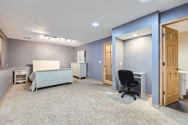 bedroom featuring carpet and rail lighting