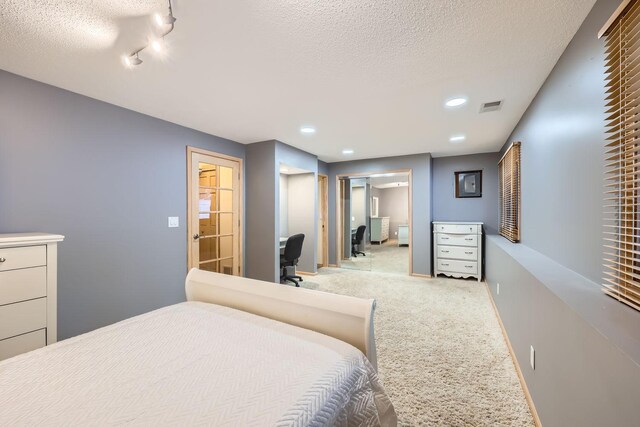 carpeted bedroom with a textured ceiling