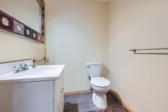 bathroom featuring tile patterned floors, vanity, and toilet