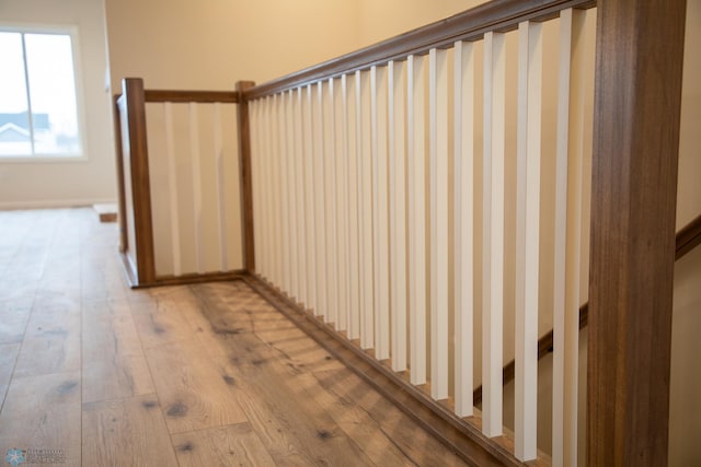 staircase with hardwood / wood-style flooring