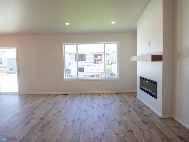 unfurnished living room featuring light hardwood / wood-style flooring