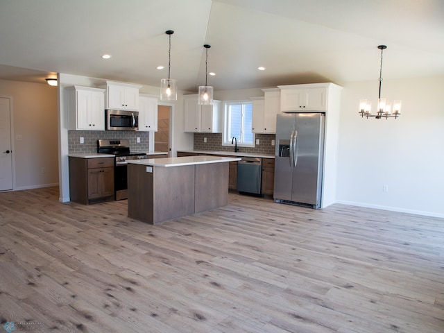 kitchen with white cabinets, a kitchen island, and stainless steel appliances