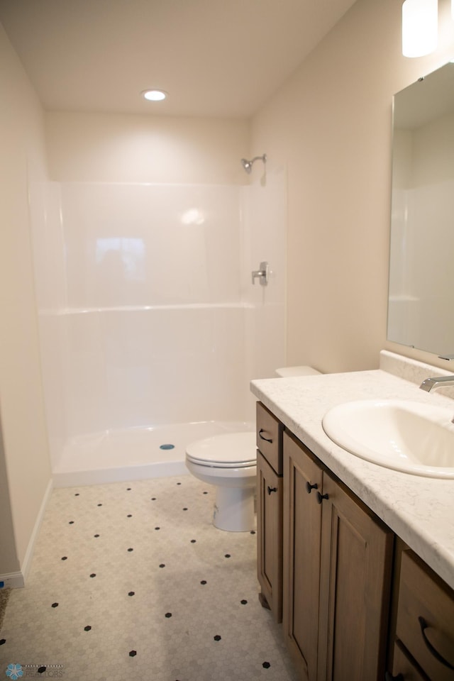 bathroom with a shower, vanity, and toilet