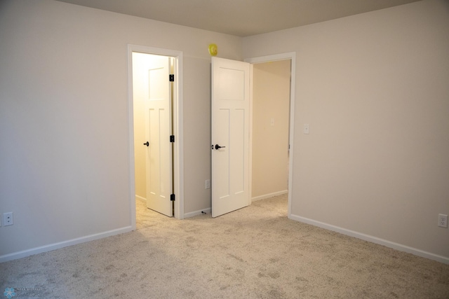 unfurnished bedroom with light colored carpet