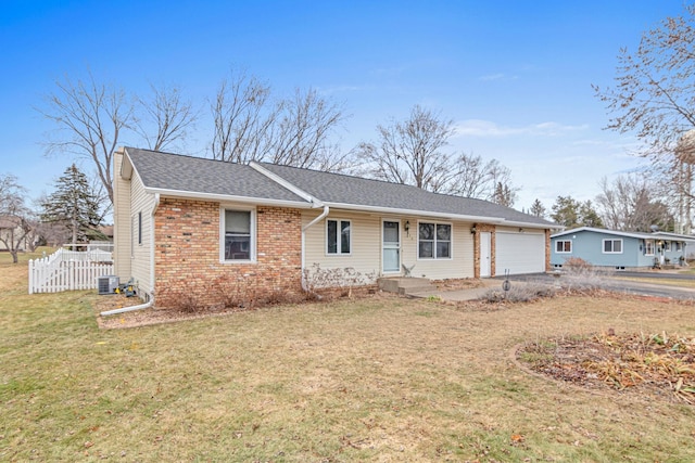 ranch-style house with a front yard, a garage, and central air condition unit