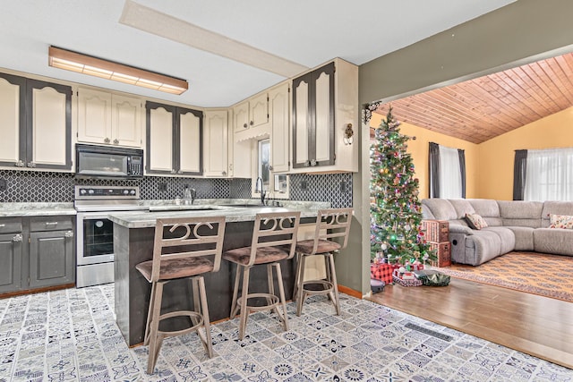 kitchen featuring decorative backsplash, gray cabinetry, stainless steel electric stove, sink, and light hardwood / wood-style floors