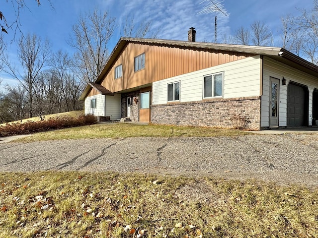 rear view of property with a garage