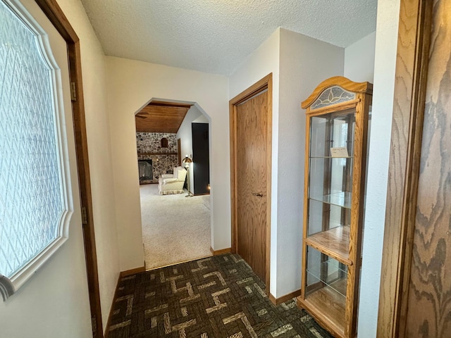 hall featuring dark parquet floors and a textured ceiling