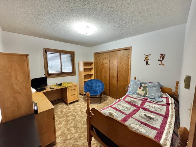 bedroom featuring a textured ceiling, light colored carpet, and a closet