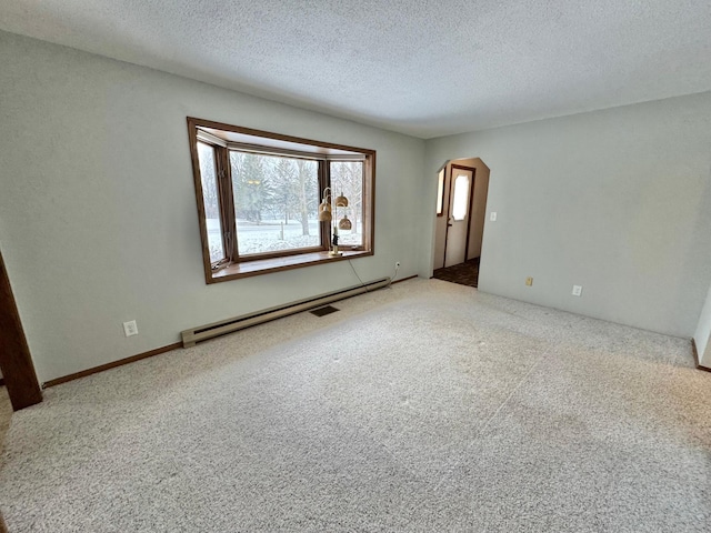 unfurnished room with baseboard heating, carpet floors, and a textured ceiling