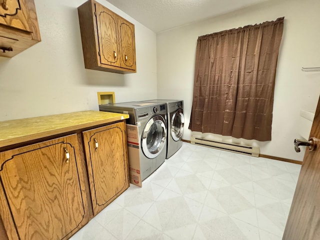 laundry room featuring washer and clothes dryer, cabinets, a textured ceiling, and a baseboard heating unit