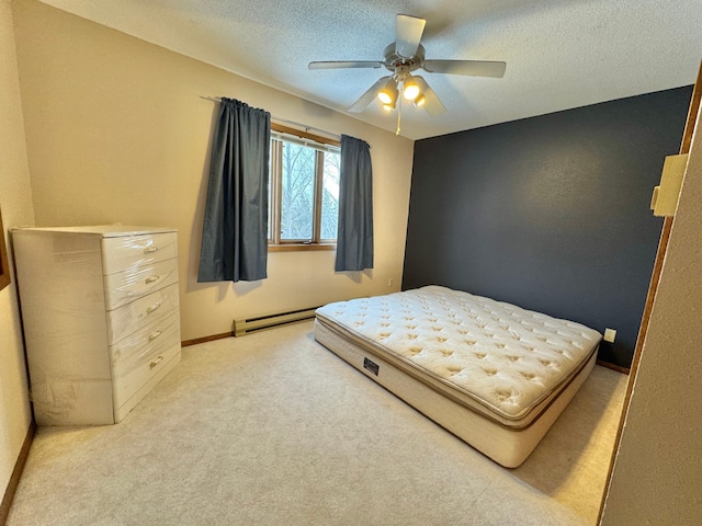 bedroom featuring ceiling fan, light colored carpet, a textured ceiling, and a baseboard heating unit