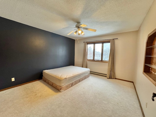 unfurnished bedroom with ceiling fan, baseboard heating, a textured ceiling, and light carpet