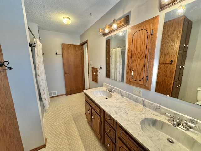 bathroom featuring vanity and a textured ceiling