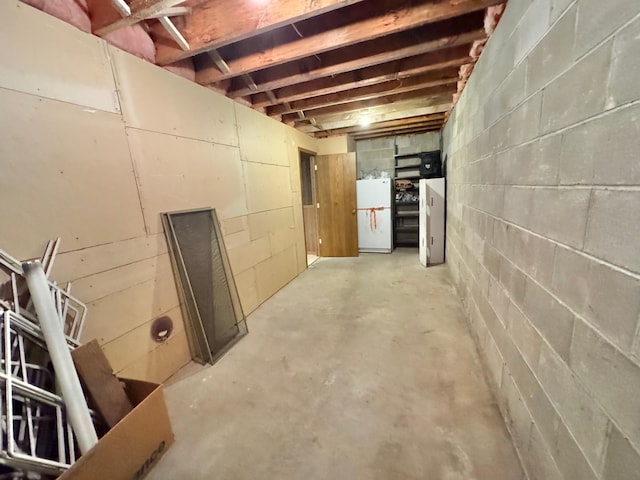 basement with white fridge