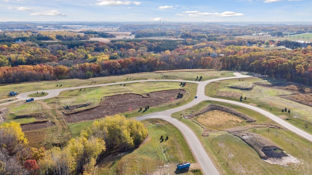 birds eye view of property with a view of trees