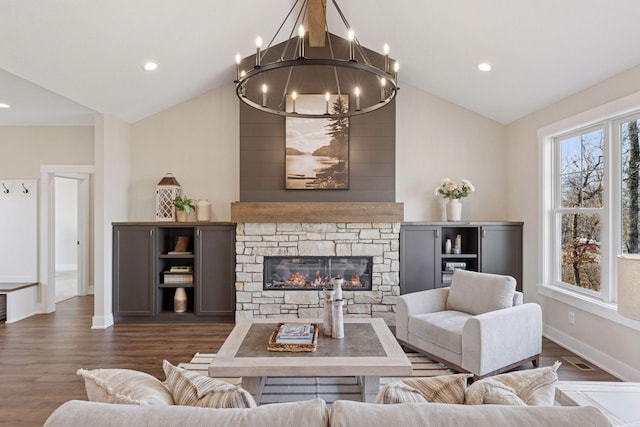 living room featuring a fireplace, an inviting chandelier, dark wood-type flooring, vaulted ceiling, and baseboards