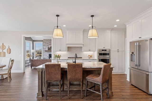 kitchen featuring stainless steel appliances, dark wood-type flooring, backsplash, and white cabinets