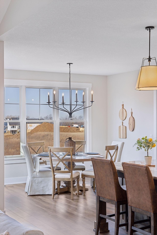 dining area with wood finished floors