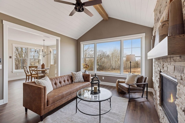 living room with vaulted ceiling with beams, a fireplace, plenty of natural light, and wood finished floors