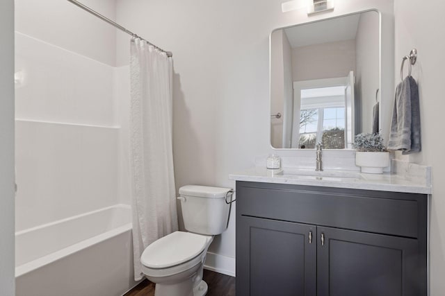 full bathroom with toilet, wood finished floors, vanity, baseboards, and shower / bath combo