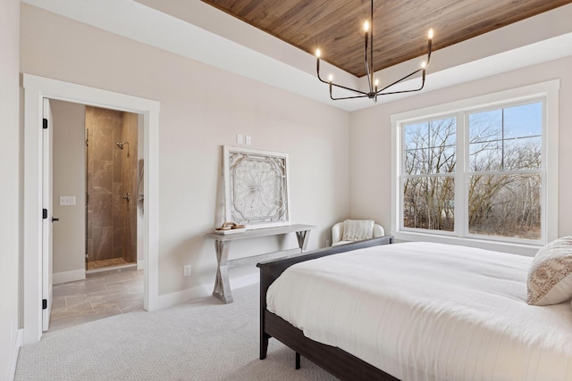 carpeted bedroom featuring baseboards, a raised ceiling, connected bathroom, wood ceiling, and an inviting chandelier