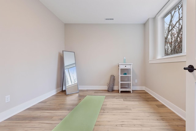 interior space featuring wood finished floors, visible vents, and baseboards