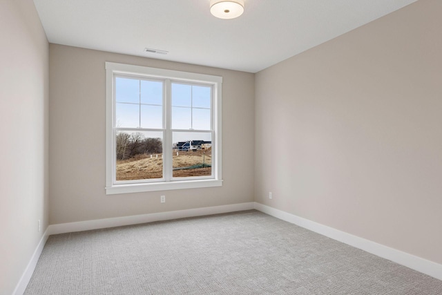 carpeted empty room with baseboards and visible vents