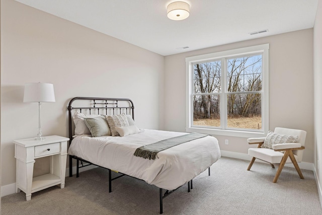 bedroom featuring light colored carpet, visible vents, and baseboards