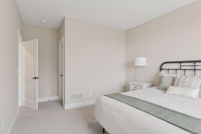 bedroom with carpet, visible vents, and baseboards